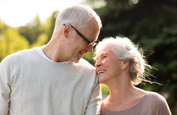 a lovly aged couple walking in a park after siging an irrevocable trust
