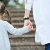 a father holding his dougthers hand