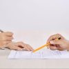 a divorce lawyer showing papers to a client